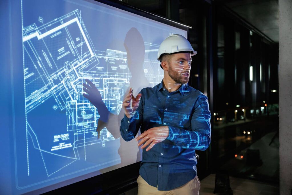 Engenheiro usando projeção para demonstrar o planejamento estratégico de obras com Inteligência Artificial na Construção Civil.